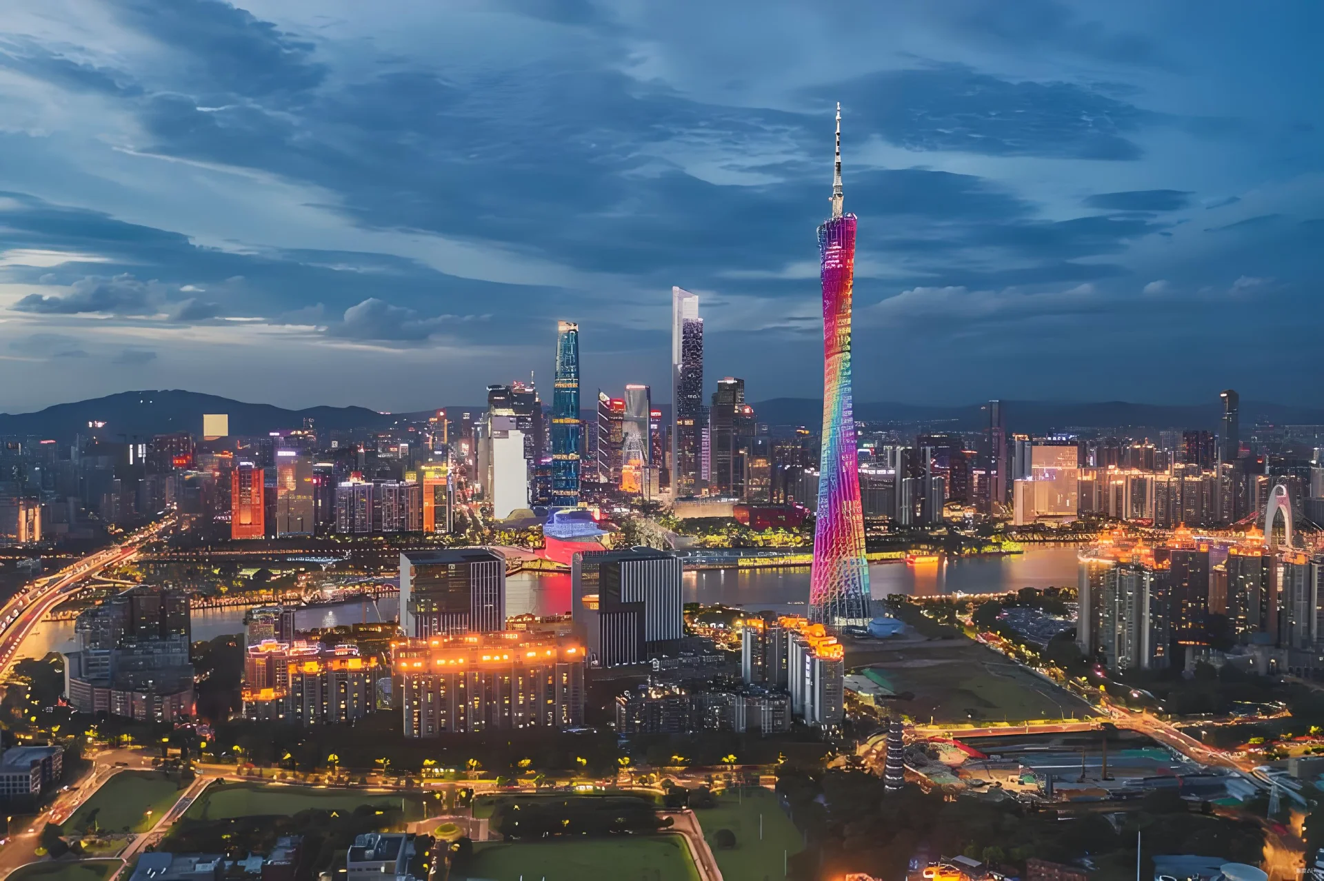 Canton Tower illuminated at night with Pearl River reflection in Guangzhou
