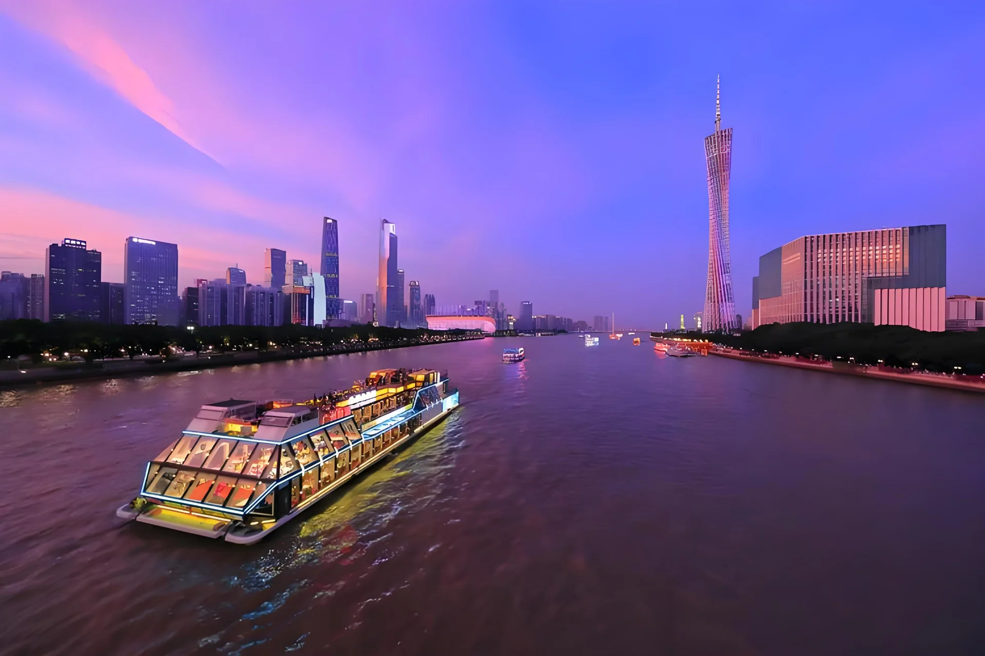 Pearl River night cruise view of illuminated Canton Tower and Guangzhou skyline
