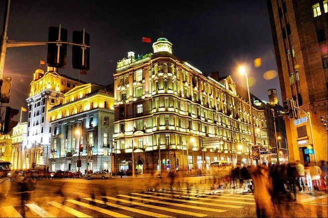 Nanjing Road pedestrian street at night with neon signs and crowds in Shanghai